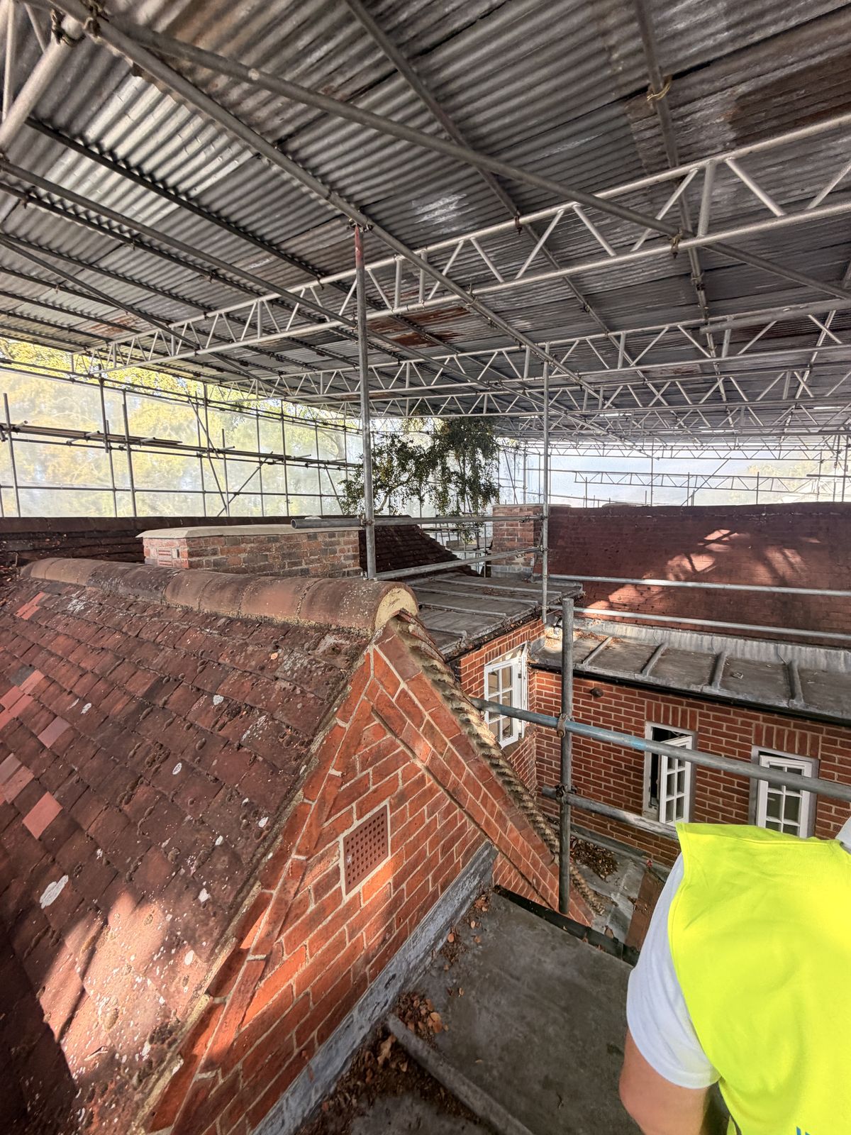 Hip and ridge tiles bedded in mortar at a brick gable