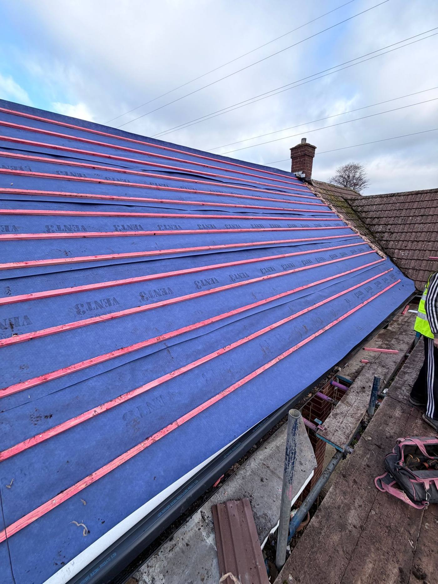 Breathable membrane being installed over rafters