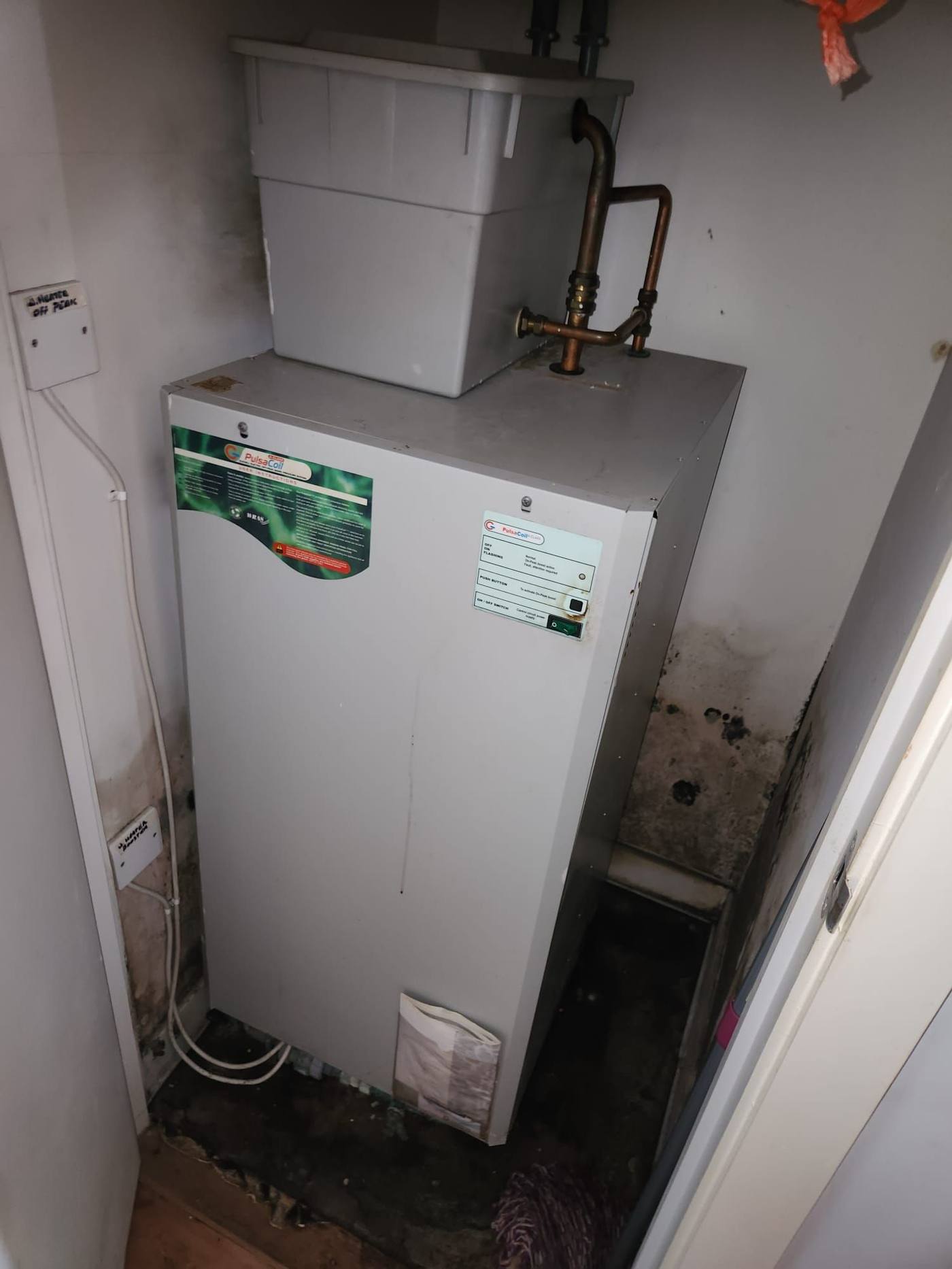 Mould growth in the cylinder cupboard around the hot water unit