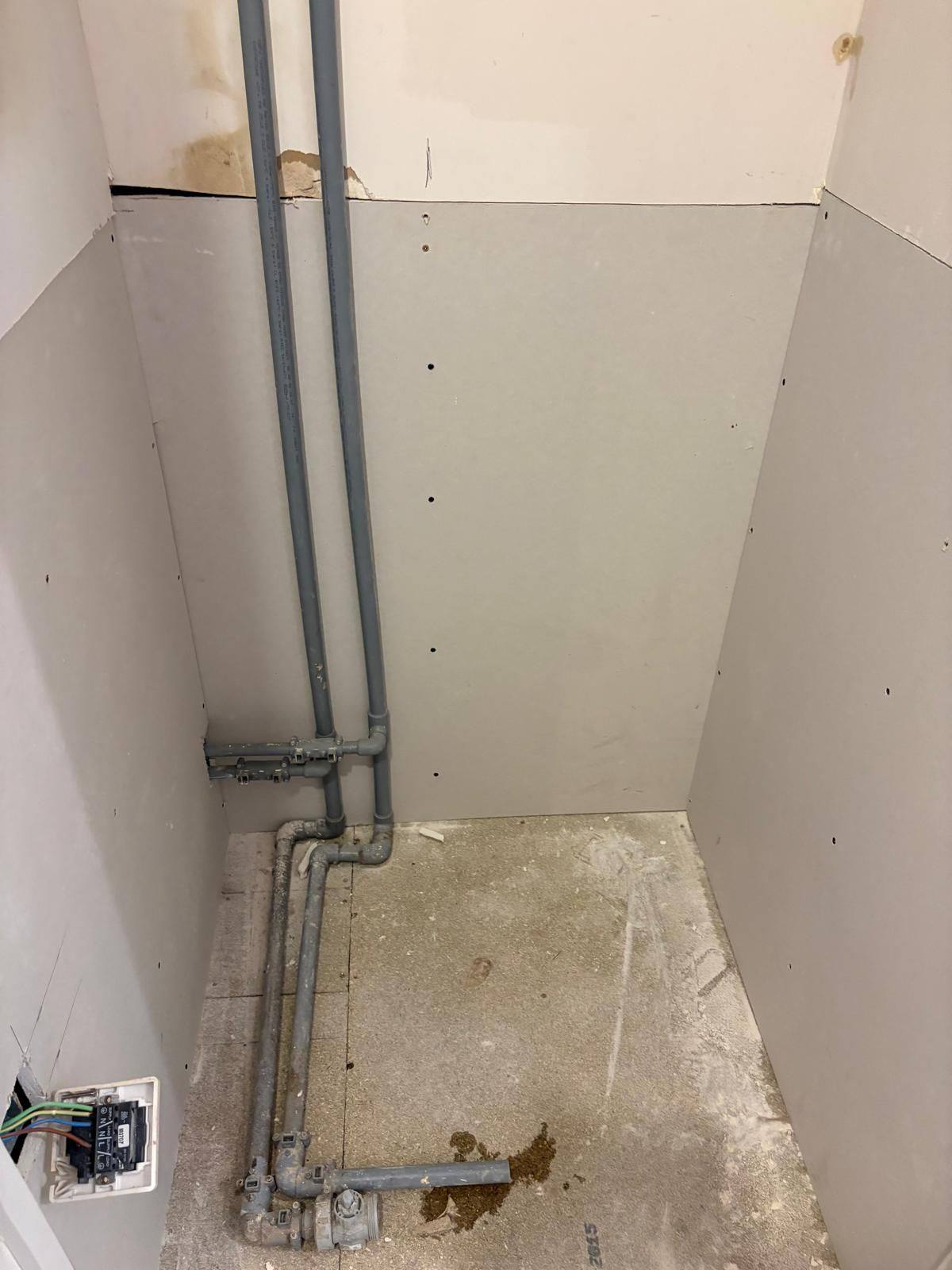 New plasterboard installed to services cupboard